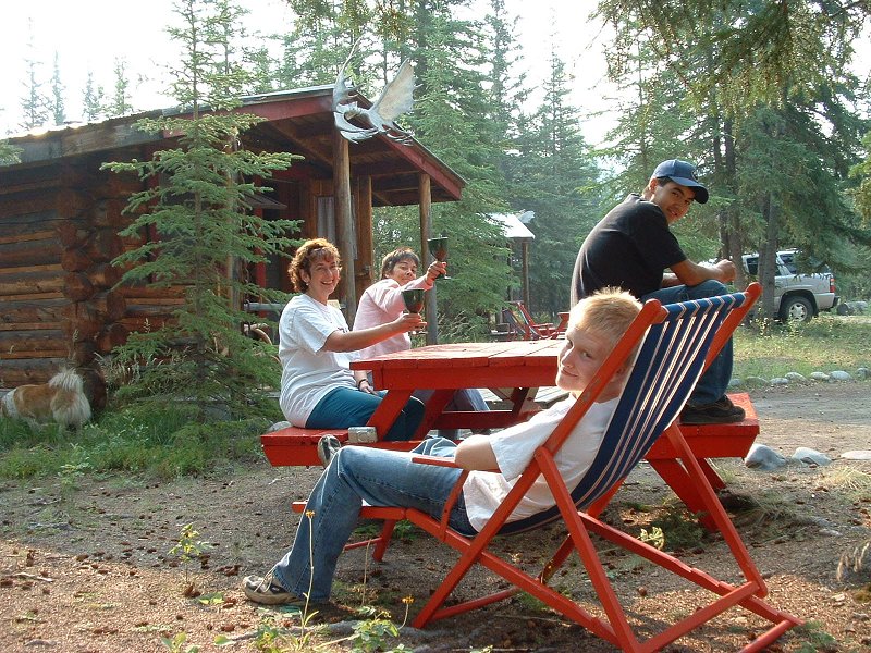 Relaxing in front of one of the log cabins at Moose Creek, Yukon.